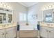 Bright bathroom with dual vanities, and a soaking tub at 2000 Farmington Ct, Clermont, FL 34711