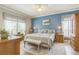 Light-filled bedroom with a feature wall, a ceiling fan, and bench seating at 2000 Farmington Ct, Clermont, FL 34711