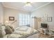 Comfortable bedroom with shuttered windows and decorative wall art at 2000 Farmington Ct, Clermont, FL 34711