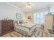 Cozy bedroom with a ceiling fan, shuttered windows, and warm wood-look flooring at 2000 Farmington Ct, Clermont, FL 34711