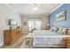 Spacious bedroom showcasing crown molding, a ceiling fan, and neutral decor at 2000 Farmington Ct, Clermont, FL 34711