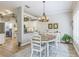 Bright dining room features a modern chandelier and an open view to the kitchen at 2000 Farmington Ct, Clermont, FL 34711