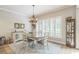 Airy dining room with shuttered windows for natural light and a decorative cabinet at 2000 Farmington Ct, Clermont, FL 34711