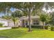 Charming single-story home with well-manicured lawn and inviting front yard landscaping with a two-car garage at 2000 Farmington Ct, Clermont, FL 34711