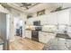 Modern kitchen with stainless appliances, decorative backsplash, and an adjoining laundry room at 2000 Farmington Ct, Clermont, FL 34711