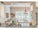 The kitchen features sleek granite countertops and a view into the adjacent dining room at 2000 Farmington Ct, Clermont, FL 34711
