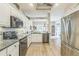 Well-equipped kitchen with stainless steel appliances, granite countertops, and white cabinetry at 2000 Farmington Ct, Clermont, FL 34711