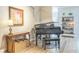 Elegant living room with a grand piano, stylish decor, and views of the built-in shelving at 2000 Farmington Ct, Clermont, FL 34711