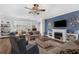 Elegant living room features a cozy fireplace, comfortable seating, and ample natural light perfect for relaxation and socializing at 2000 Farmington Ct, Clermont, FL 34711
