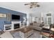 Inviting living room featuring a cozy fireplace, stylish furnishings, and ample natural light for a warm ambiance at 2000 Farmington Ct, Clermont, FL 34711