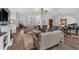 Open-concept living room with hardwood floors, comfortable seating, and a piano, perfect for relaxation and entertaining at 2000 Farmington Ct, Clermont, FL 34711