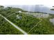Expansive aerial view of a wooded lot with a luxurious home and waterfront access at 13450 E Lake Mary Jane Rd, Orlando, FL 32832