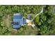 An aerial view of a property surrounded by dense trees featuring a large home, long driveway and a private pool at 13450 E Lake Mary Jane Rd, Orlando, FL 32832