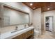 Spacious bathroom featuring double sinks, shower, toilet, wood ceiling and tile flooring at 13450 E Lake Mary Jane Rd, Orlando, FL 32832
