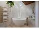 Modern bathroom features a freestanding tub, skylight, and heated towel rack at 13450 E Lake Mary Jane Rd, Orlando, FL 32832