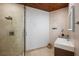Modern bathroom features walk-in shower, tile walls, wood ceiling, and floating vanity sink at 13450 E Lake Mary Jane Rd, Orlando, FL 32832