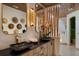 Modern bathroom with dual sinks, wood cabinets, custom mirrors, and a walk in shower at 13450 E Lake Mary Jane Rd, Orlando, FL 32832
