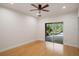 Bright bedroom with hardwood floors and sliding glass door leading to outside at 13450 E Lake Mary Jane Rd, Orlando, FL 32832