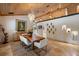Elegant dining room featuring a wood table, modern chandelier, and unique wall decor at 13450 E Lake Mary Jane Rd, Orlando, FL 32832