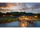 Picturesque waterfront property featuring a charming dock with lighting and seating, perfect for relaxing at 13450 E Lake Mary Jane Rd, Orlando, FL 32832