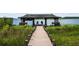 Picturesque wooden dock with covered gazebos, perfect for enjoying lake views at 13450 E Lake Mary Jane Rd, Orlando, FL 32832