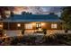 Charming home with well-lit facade and beautiful landscaping at twilight at 13450 E Lake Mary Jane Rd, Orlando, FL 32832