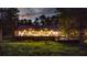 Stunning view of the back exterior of a home with large windows and a spacious deck overlooking the yard at 13450 E Lake Mary Jane Rd, Orlando, FL 32832