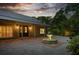 Charming exterior view of a home with a beautiful fountain and well-lit landscaping at dusk at 13450 E Lake Mary Jane Rd, Orlando, FL 32832