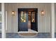 Inviting entryway featuring a modern black double door with stylish lighting fixtures at 13450 E Lake Mary Jane Rd, Orlando, FL 32832