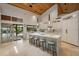 Bright kitchen featuring marble island with seating, custom cabinets and modern lighting fixtures at 13450 E Lake Mary Jane Rd, Orlando, FL 32832