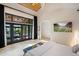 Bright main bedroom features king bed, vaulted wood ceiling, and access to outdoor views at 13450 E Lake Mary Jane Rd, Orlando, FL 32832