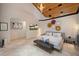 Spacious main bedroom with king bed, vaulted ceiling, wood accents and modern decor at 13450 E Lake Mary Jane Rd, Orlando, FL 32832