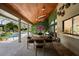 Charming outdoor dining area on a covered patio, complemented by a lush green wall and view of the pool at 13450 E Lake Mary Jane Rd, Orlando, FL 32832