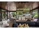 Covered outdoor living area with kitchen, dining, and lounge areas offers great comfort at 13450 E Lake Mary Jane Rd, Orlando, FL 32832
