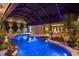 Beautifully landscaped pool area with vibrant plants, rock features, and unique lighting creating a relaxing atmosphere at 13450 E Lake Mary Jane Rd, Orlando, FL 32832