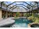 Gorgeous pool with mature landscaping and glass enclosure offers privacy and sunlight at 13450 E Lake Mary Jane Rd, Orlando, FL 32832