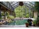 Stunning screened-in pool area surrounded by lush plants and flowers, creating a private oasis for relaxation at 13450 E Lake Mary Jane Rd, Orlando, FL 32832