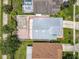 Aerial view of the property showing the layout, patio, and proximity to neighboring homes and lush greenery at 1437 Abberton Dr, Orlando, FL 32837