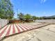 Expansive backyard area featuring a white fence, mature trees, and patio at 1437 Abberton Dr, Orlando, FL 32837