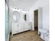 Bright bathroom featuring a modern double sink vanity, decorative lighting, and closet access at 1437 Abberton Dr, Orlando, FL 32837