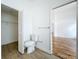 Bathroom featuring a toilet, closet with bi-fold door, and doorway access to another room at 1437 Abberton Dr, Orlando, FL 32837