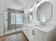 Bathroom features a glass enclosed shower, dual vanity, and modern lighting at 1437 Abberton Dr, Orlando, FL 32837