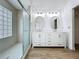 Bright bathroom with modern double sink vanity, decorative lighting, and glass-enclosed shower at 1437 Abberton Dr, Orlando, FL 32837