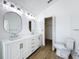 Bathroom featuring a modern double sink vanity, decorative lighting, toilet, and closet access at 1437 Abberton Dr, Orlando, FL 32837