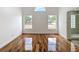 Bright bedroom boasts glossy wood floors and lots of natural light from large windows at 1437 Abberton Dr, Orlando, FL 32837