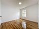 A bedroom featuring wood-look floors, a window, and white trim at 1437 Abberton Dr, Orlando, FL 32837