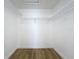 A small closet featuring shelving, bright lighting, and wood-look floors at 1437 Abberton Dr, Orlando, FL 32837