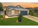 Charming single-Gathering home featuring well-maintained landscaping, a two-car garage, and a neatly manicured lawn at 1437 Abberton Dr, Orlando, FL 32837