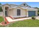 Charming single-Gathering home with a well-manicured lawn and blue two car garage door at 1437 Abberton Dr, Orlando, FL 32837
