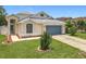 Charming single-Gathering home with a well-manicured lawn and blue two car garage door at 1437 Abberton Dr, Orlando, FL 32837